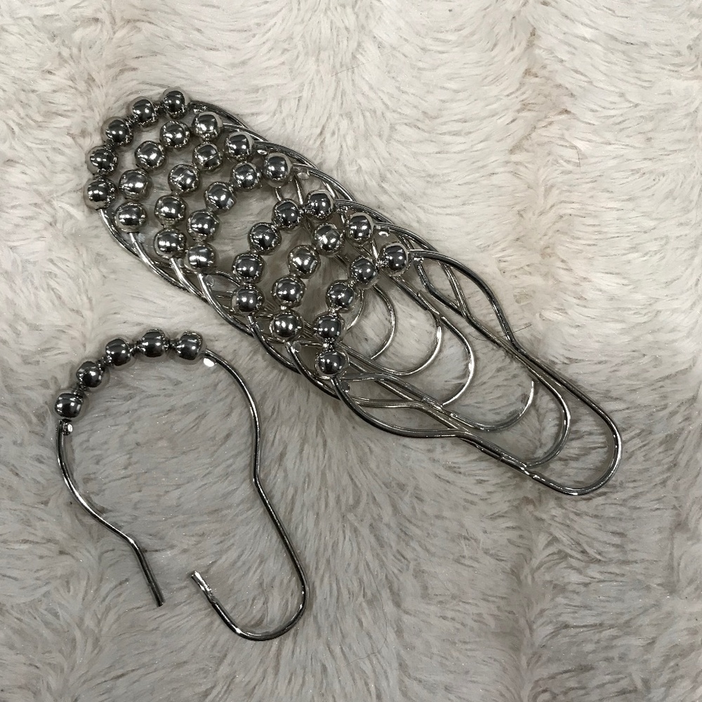 Metal hooks and bathroom shower curtain.